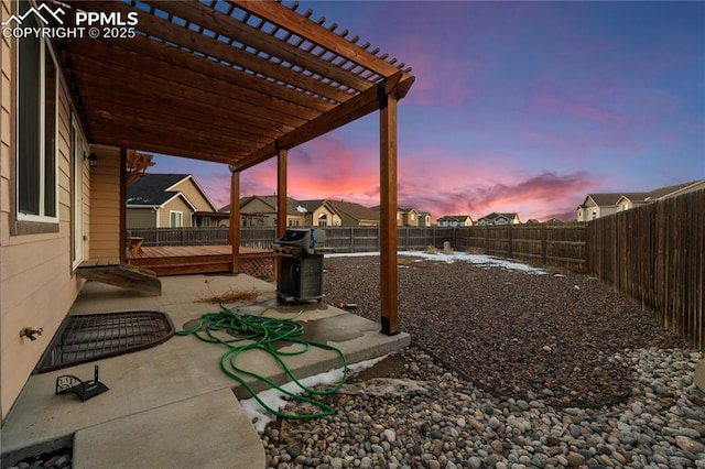 yard at dusk with a pergola and a patio