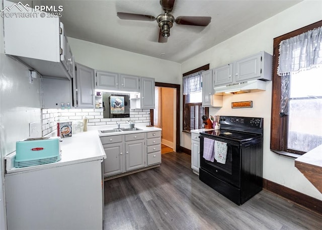 kitchen with gray cabinetry, sink, tasteful backsplash, and electric range