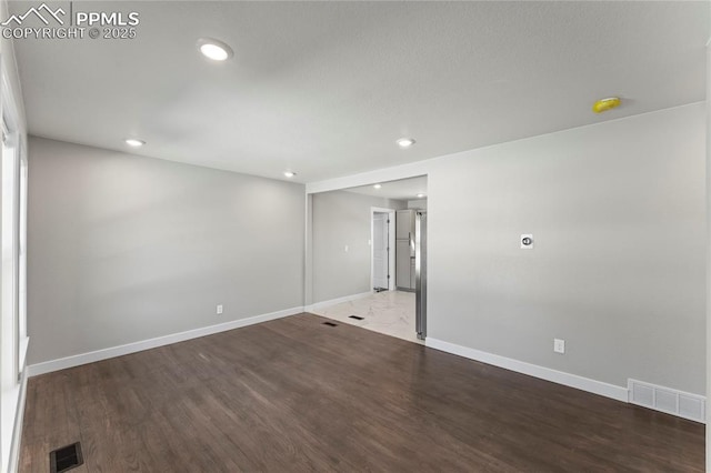 unfurnished room featuring dark hardwood / wood-style floors