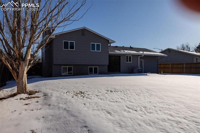 view of snow covered back of property