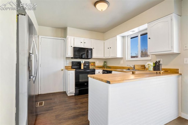 kitchen with dark hardwood / wood-style floors, black appliances, white cabinetry, sink, and kitchen peninsula