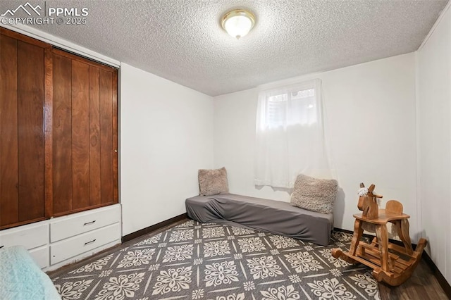 bedroom with hardwood / wood-style flooring and a textured ceiling