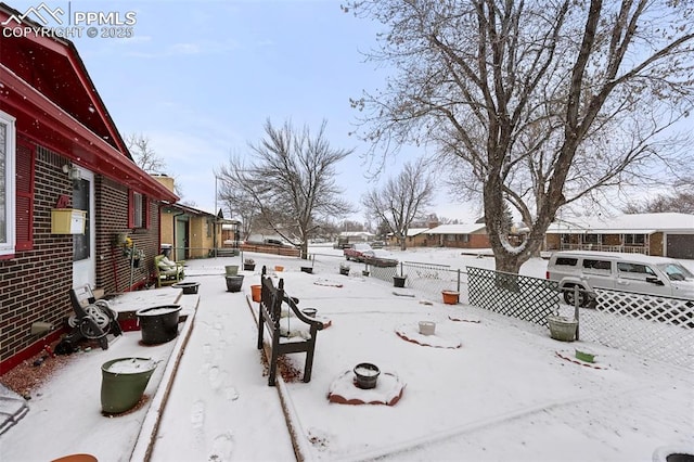 view of yard layered in snow