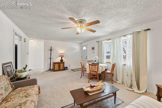 living room featuring light colored carpet, a textured ceiling, and ceiling fan