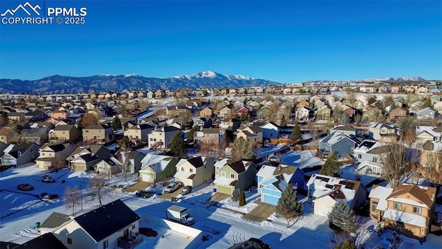 snowy aerial view featuring a mountain view