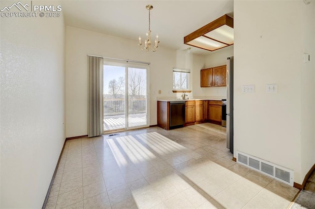 kitchen with decorative light fixtures, dishwasher, sink, light tile patterned floors, and an inviting chandelier