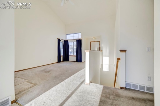 foyer featuring carpet floors and high vaulted ceiling