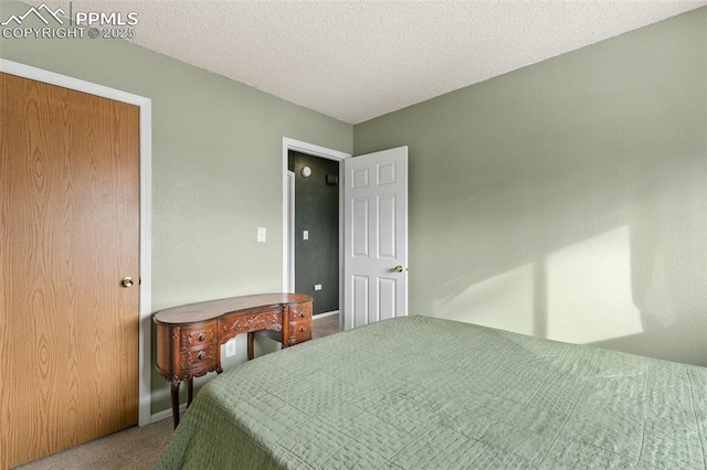 carpeted bedroom featuring a textured ceiling