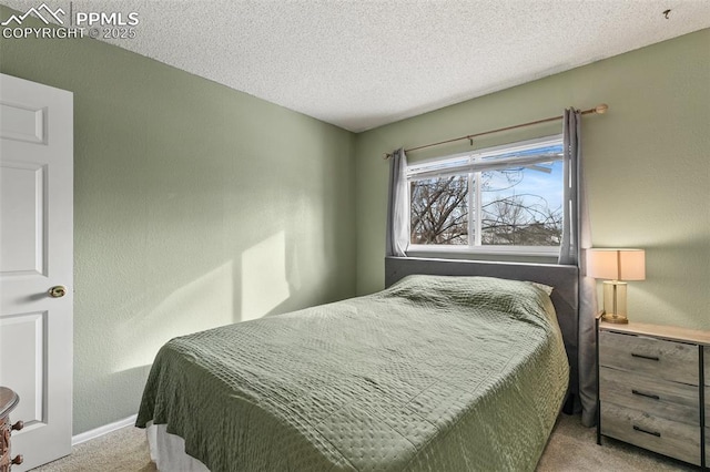 carpeted bedroom featuring a textured ceiling