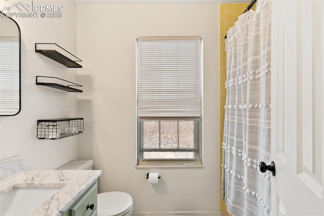 bathroom featuring vanity, a shower with shower curtain, and toilet