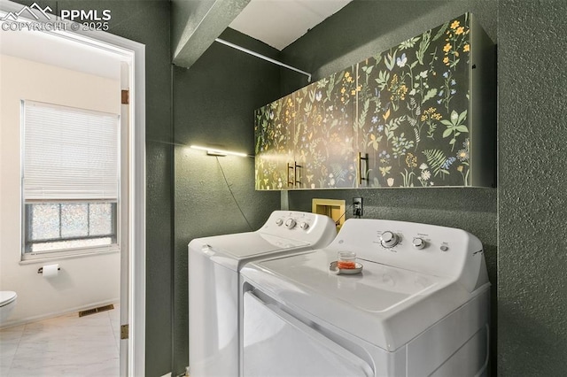 laundry room featuring separate washer and dryer