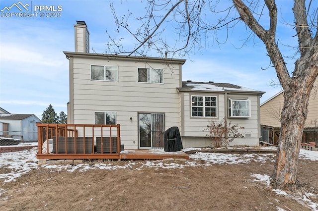 snow covered house with a deck