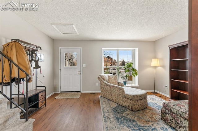 entrance foyer with wood-type flooring and a textured ceiling