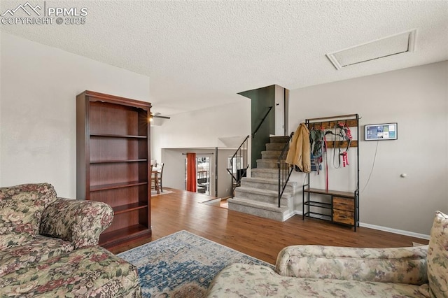 living room with hardwood / wood-style flooring and a textured ceiling