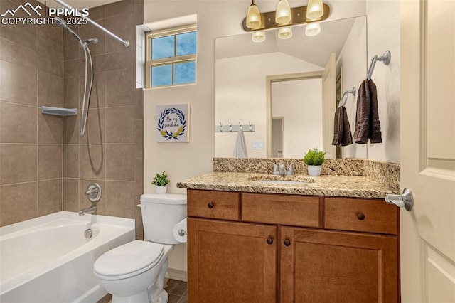 full bathroom featuring vanity, tiled shower / bath, and toilet