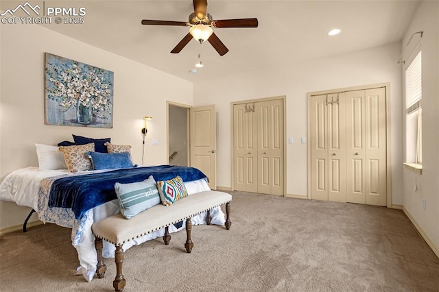 bedroom featuring two closets, ceiling fan, and carpet