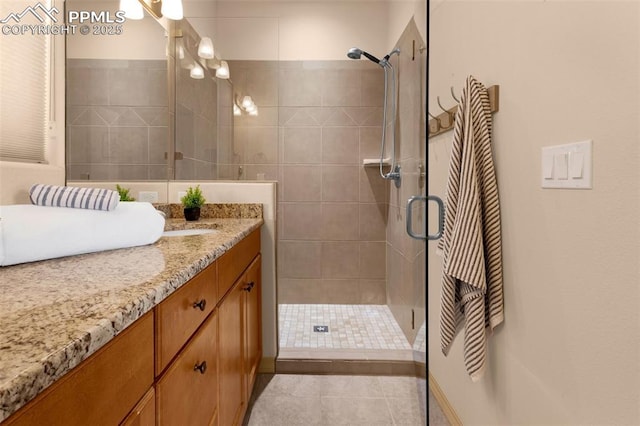 bathroom with vanity, tile patterned flooring, and a shower with door