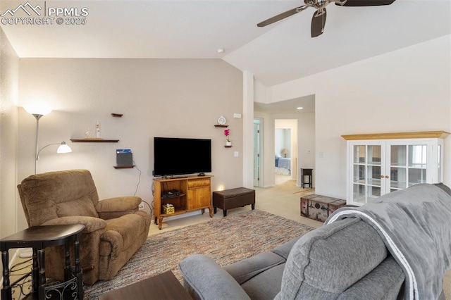 carpeted living room with french doors, ceiling fan, and lofted ceiling