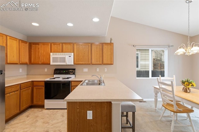 kitchen with sink, a breakfast bar area, an inviting chandelier, decorative light fixtures, and white appliances