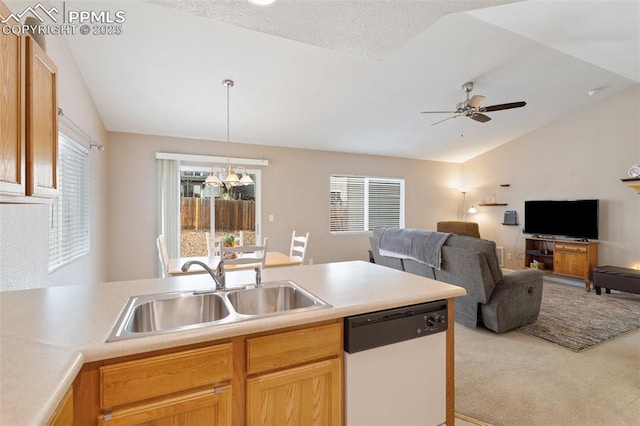 kitchen with vaulted ceiling, ceiling fan with notable chandelier, dishwasher, sink, and light carpet