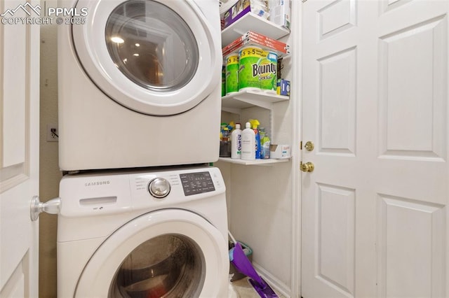 laundry area featuring stacked washer / drying machine