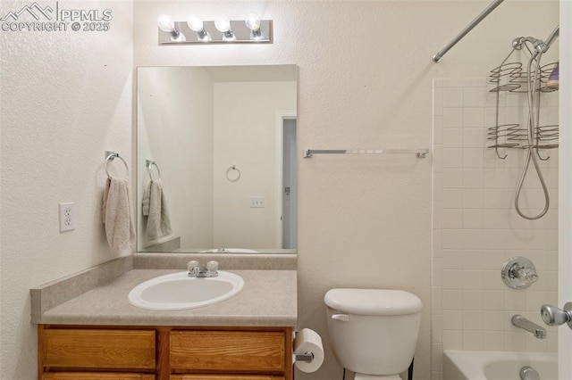 full bathroom featuring vanity, tiled shower / bath combo, and toilet