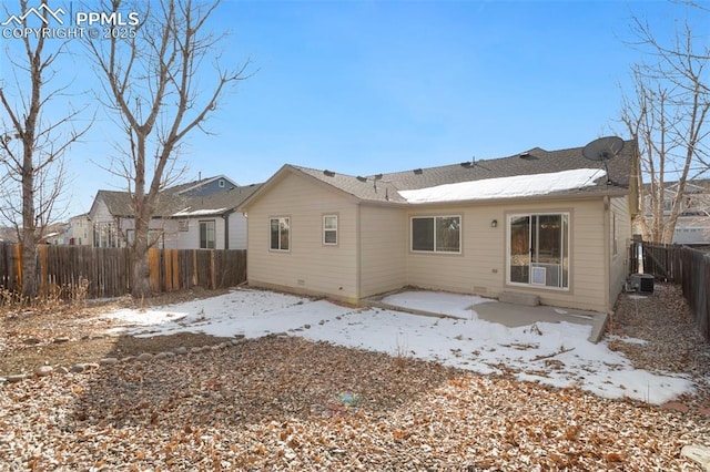 snow covered house with a patio and central air condition unit