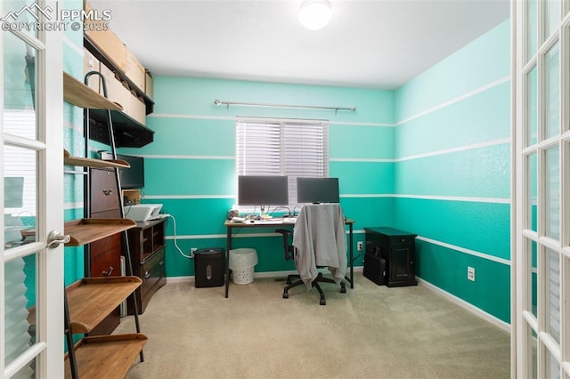 office with light carpet and french doors