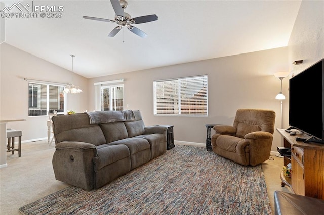 living room with vaulted ceiling, carpet, and ceiling fan with notable chandelier