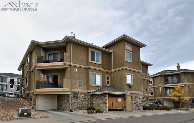 view of building exterior featuring cooling unit and a garage