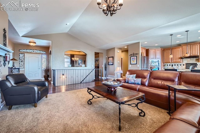 living room featuring hardwood / wood-style flooring, a chandelier, vaulted ceiling, and a wealth of natural light