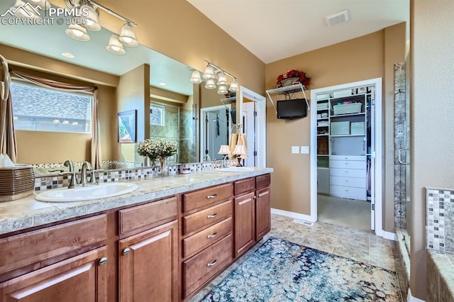 bathroom featuring walk in shower and vanity