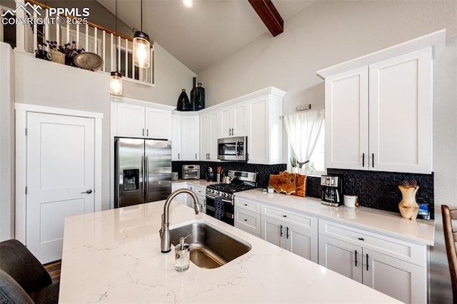 kitchen featuring stainless steel appliances, sink, and white cabinets