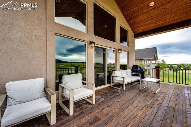 wooden terrace with an outdoor living space