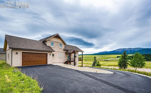 view of front facade featuring a garage and a mountain view