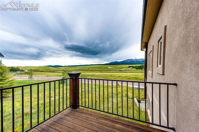 wooden terrace with a mountain view and a rural view