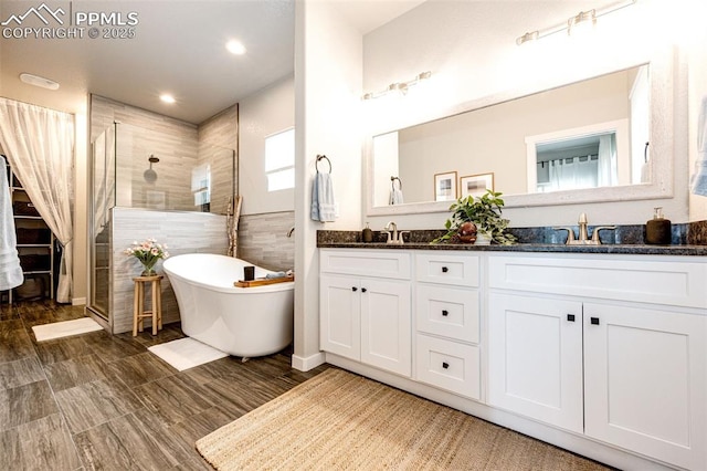 bathroom featuring vanity and shower with separate bathtub