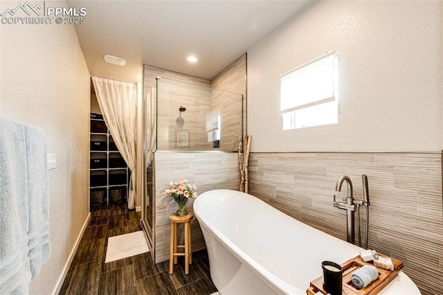 bathroom featuring tile walls and plus walk in shower