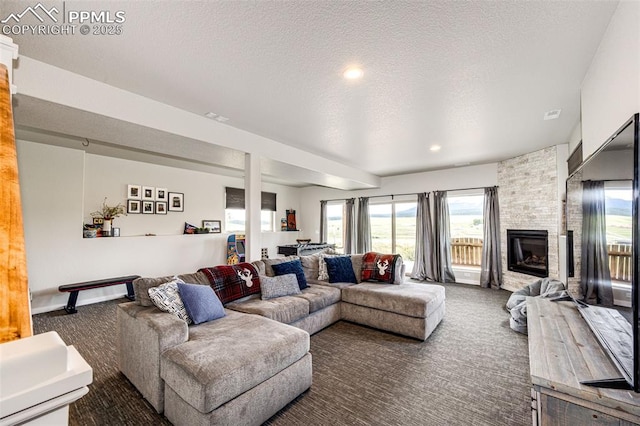 carpeted living room with a fireplace and a textured ceiling