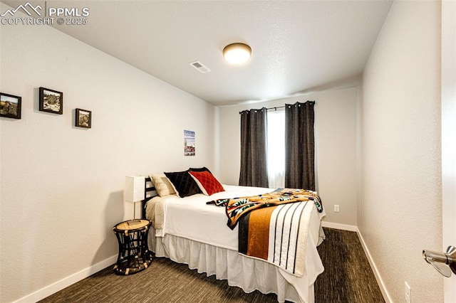 bedroom with dark wood-type flooring