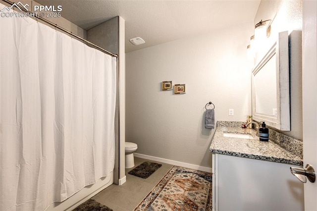 bathroom with vanity, tile patterned flooring, and toilet