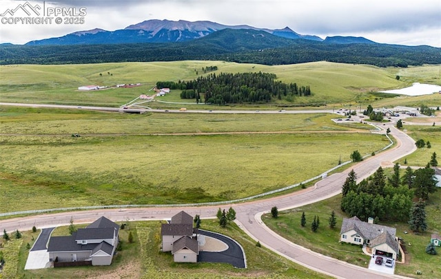 drone / aerial view featuring a mountain view and a rural view