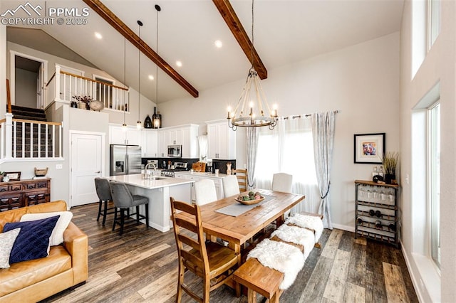 dining area featuring an inviting chandelier, hardwood / wood-style floors, a towering ceiling, and a wealth of natural light