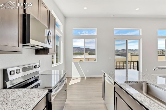 241 N Front St Unit 101, Monument, CO 80132 - kitchen featuring recessed lighting, plenty of natural light, stainless steel appliances, and a sink