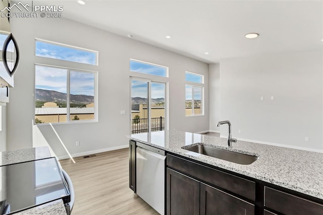 241 N Front St Unit 101, Monument, CO 80132 - kitchen featuring dishwasher, recessed lighting, a sink, and light wood-style floors