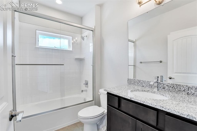 241 N Front St Unit 101, Monument, CO 80132 - full bathroom with tile patterned floors, vanity, enclosed tub / shower combo, and toilet