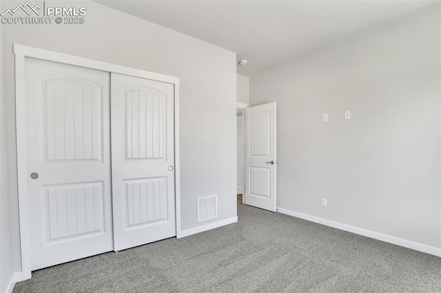 241 N Front St Unit 101, Monument, CO 80132 - unfurnished bedroom with carpet floors, a closet, visible vents, and baseboards