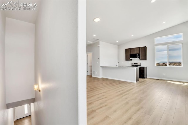 241 N Front St Unit 101, Monument, CO 80132 - unfurnished living room with recessed lighting, vaulted ceiling, baseboards, and light wood-type flooring