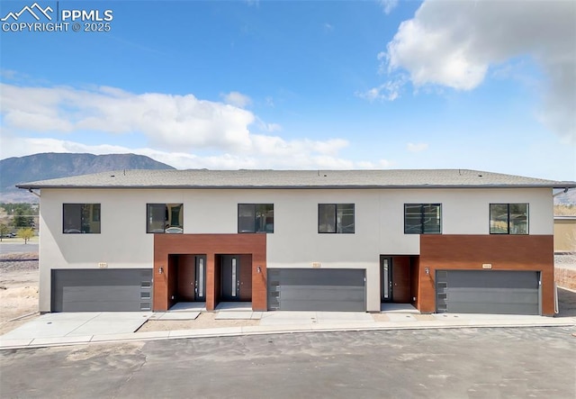 241 N Front St Unit 101, Monument, CO 80132 - modern home with stucco siding, an attached garage, and a mountain view