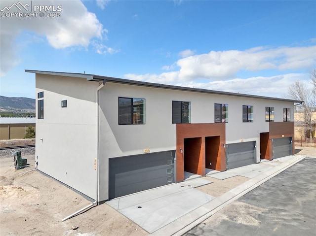 241 N Front St Unit 101, Monument, CO 80132 - modern home featuring a garage and stucco siding